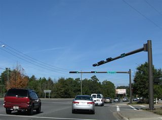 SR 368 (W 23rd Street) turns northward through S-curve around Gulf Coast State College to a signalized intersection with Collegiate Drive west and W 22nd Street east.
