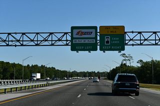 The Central Florida GreeneWay turns more easterly across the Little Econ River to the University Mainline Toll Plaza.