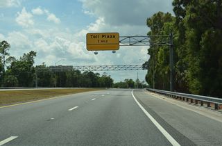 Traffic slows to the Celebration Toll Plaza. The six lane plaza is the last on Orlando area expressways without open road tolling.