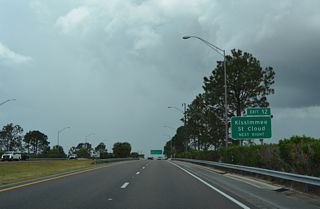 A systems interchange (Exit 12) joins SR 417 south with Florida's Turnpike north to Orlando and Clermont and south to Kissimmee and St. Cloud in one mile. This sign was removed in 2024.