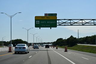 West from Lake Nona Boulevard, SR 417 runs just south of Mud Lake and the perimeter of Orlando International Airport (MCO).