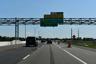 SR 417 passes between the Villagewalk at Lake Nona and Lareate Park developments of Lake Nona ahead of the diamond interchange (Exit 19) with Lake Nona Boulevard.