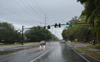An S-curve turns CR 424 south from Highland Avenue onto Old Dixie Highway ahead of Schopke Lester Road. Old Dixie Highway continues along the back side of retail situated along U.S. 441 to Errol Parkway and the Parkside at Errol Estates.