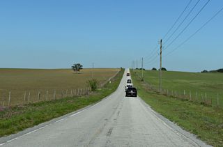 CR 575 (Trilby Road) turns east at Harris Hill Road across ranch land south of Block Pond.