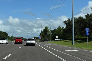A trailblazer for CR 54 directs motorists northward along SR 581 (Bruce B. Downs Boulevard) from the Shops at Wiregrass retail complex. SR 581 was designated to provided connectivity between SR 54 and SR 56 following the relinquishment of Wesley Chapel Boulevard (CR 54) to Pasco County.