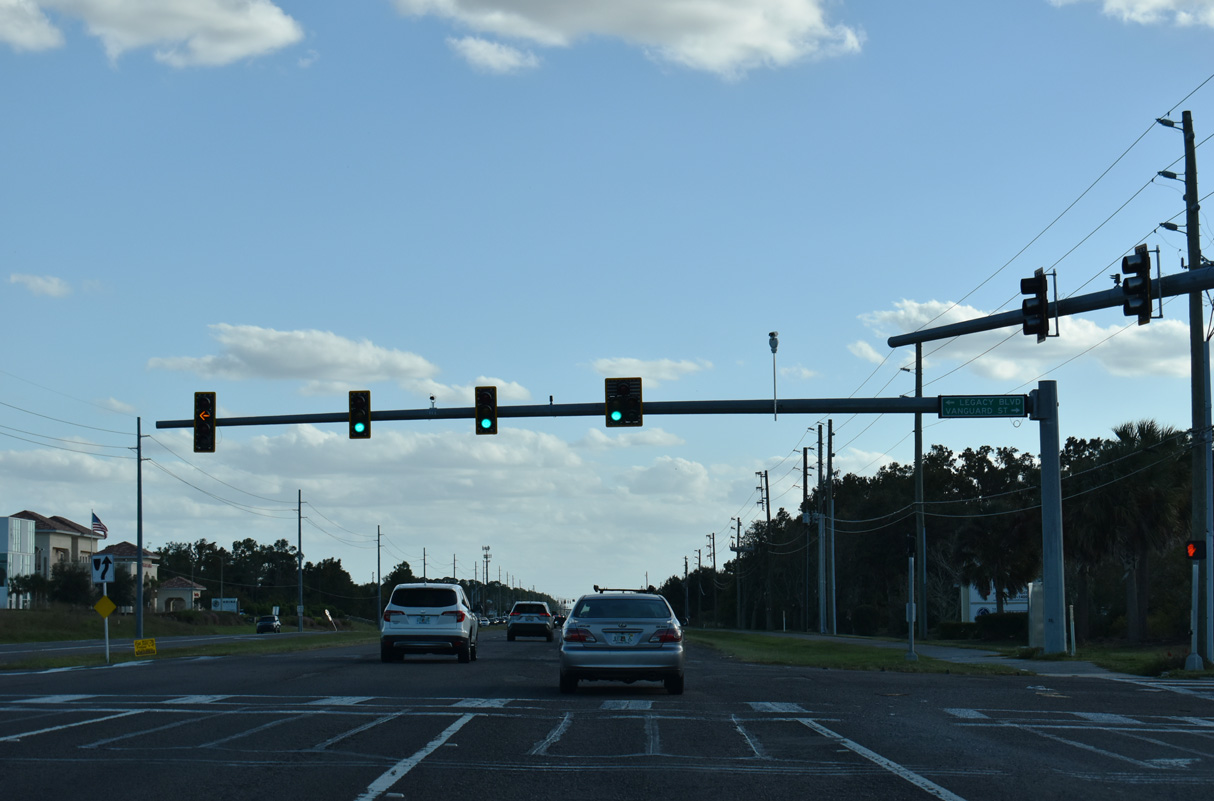 CR 581 (Bruce B. Downs Boulevard) passes by AdventHealth Wesley Chapel hospital ahead of the signal with Legacy Boulevard east and Vanguard Street west.