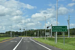 A toll gantry collects fees for traffic departing SR 589 south at Exit 68.