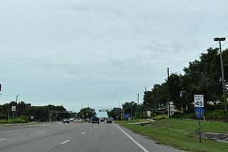 Continuing south from SR 590, CR 611 (McMullen-Booth Road) wholly enters the city of Clearwater across Alligator Creek.