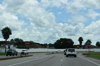 Henley Drive curves southward from SR 21 (Blanding Boulevard) to a stop sign with Talisman Drive in the Mayfield neighborhood.