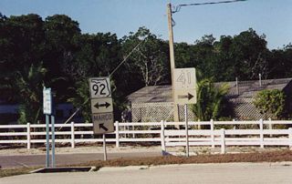 SR 92 and faded orange U.S. 41 markers previously posted at the west end of CR 892 (Goodland Drive).