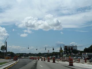 An at-grade intersection joined Arlington Expressway with Mill Creek Road north prior to the flyover project at Southside Boulevard. A right in and right out movement replaced this signal.