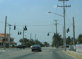 Northbound Kennedy Drive at U.S. 1 (North Roosevelt Boulevard). U.S. 1 south continues through the commercial district toward White Street and Downtown. U.S. 1 north hugs the Gulf of Mexico waters east to SR A1A (South Roosevelt Boulevard) at the Overseas Highway to Stock Island. Sigsbee Road continues Kennedy Drive north to the U.S. Naval Housing complex on Dredgers Key.