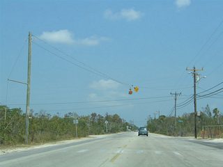 A flasher hangs above the intersection of Key Deer Boulevard and South Street advising 15 miles per hour for the adjacent baseball field. Continuing north, Key Deer Boulevard intersects Watson Boulevard, the original Overseas Highway