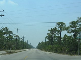 Southbound at the intersection with Palm Avenue. Palm Avenue travels west to Narcissus Avenue south. Both roads intersect Watson Boulevard (the original Overseas Highway) to the south. Watson Boulevard travels west to a dead end at Pine Channel and east to No Name Key.