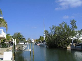 Canals are often incorporated into South Florida and Keys neighborhoods. They not only create more waterfront property, but also provide access to the bays, gulf, and ocean for water enthusiasts. Pictured here are two scenes of a neighborhood canal in Key Largo.