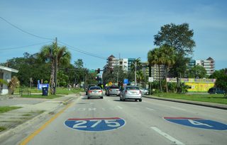 Painted shields accompany the sign bridge along Scott Street east for the separate on-ramps to Interstate 275 north. The right side ramp provides access to the adjacent eastbound beginning of I-4.