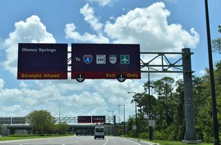 Buena Vista Drive enters a parclo interchange with Epcot Center Drive east of Backstage Lane north and Chelonia Parkway south.