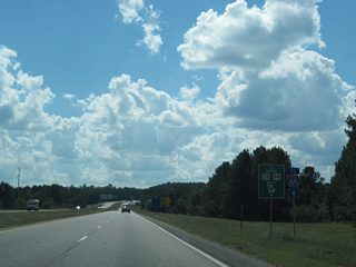 Trailblazer signage posted ahead of the College Station Road underpass directs motorists headed for SR 316 west, U.S. 129 north and U.S. 441 north to remain along the Athens Perimeter Highway west into Oconee County and north back into Athens. A shorter route to the U.S. Highways north is to turn around at forthcoming Exit 6.
