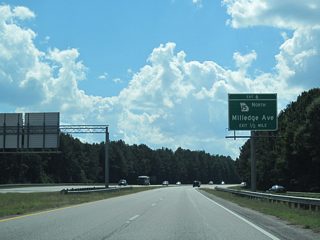 Curving west by Oconee Forest Park, the Athens Perimeter Highway advances toward the modified diamond interchange (Exit 6) with SR 15 Alternate (Milledge Avenue) north.