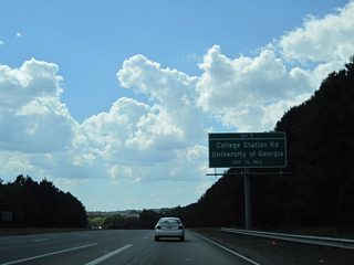 U.S. 78 accompanies SR 10 Loop and U.S. 129-441/SR 8-15 southwest from Lexington Road. The six route overlap crosses the North Oconee River ahead of the diamond interchange (Exit 7) with College Station Road.