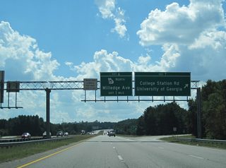 College Station Road leads west from Exit 7 to East Campus Road and the University of Georgia. The four lane arterial extends southeast to Barnett Shoals Road at College Station Shopping Center.