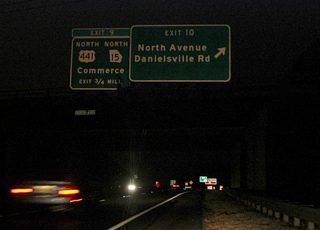 Leading west from U.S. 29, drivers on the Athens Perimeter Highway quickly enter a parclo B2 interchange (Exit 11 / old Exit 10) with Danielsville Road and North Avenue. Danielsville Road is an old alignment of U.S. 29.
