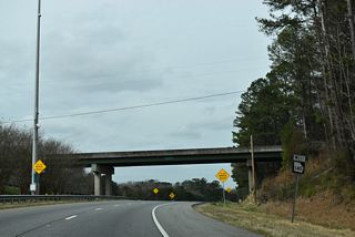 SR 20/140 separate from I-575 south along an expressway spur with SR 5 Business linking to Marietta Highway in the city of Canton.