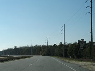 Curving westward, U.S. 25/84/301 advance from Morgan Lake Road across Patterson Swamp.