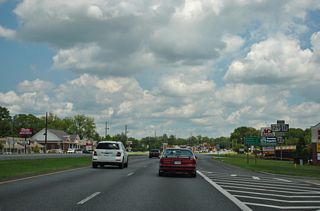 The former confirming markers for U.S. 129/SR 11-22 posted along Clinton Street east of the separation with SR 18 (Bill Conn Parkway). The distance sign remains as of 2023.
