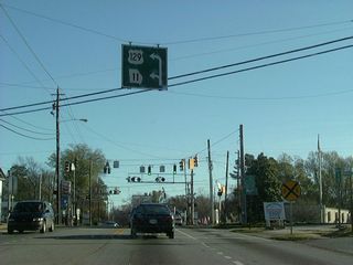 A diagrammatic sign for the turns of SR 11 and U.S. 129 north off Clinton Street in Gray.