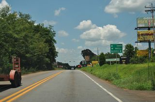 SR 212 (Kinderhook Road) travels southeast to the Baldwin County seat of Miledgeville and northwest to the Jasper County seat of Monticello.