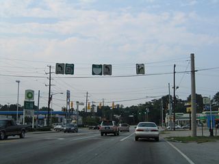 This scene looks at former span wire signs preceding the intersection of White Bluff Road north with DeRenne Avenue (SR 21). SR 21 accompanies Interstate 516 west from Montgomery Street along W.F. Lynes Parkway.