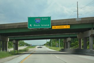 Passing under a set of 1970-built overpasses, drivers on Iowa 22 approach the eastbound on-ramp for Interstate 280.