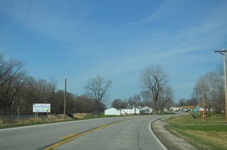 Motorists on Iowa 22 west next reach the unincorporated village of Montpelier. A welcome sign preceding Scott Street lists the community founding date as May 9, 1881.