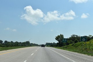Curving east, U.S. 34/63 meet Iowa 163 ahead at a parclo interchange.