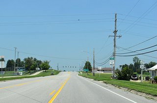 U.S. 63 (Harding Street) enters the seat of Tama County ahead of a folded diamond interchange with U.S. 30.