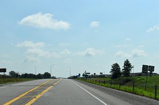 U.S. 63 turns north into the Bloomfield street grid along Washington Street while Iowa 2 angles southeast for Pulaski and Milton.