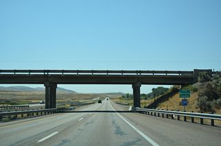 Interstate 15 south enters Bannock County at the Ross Fork Road over crossing within the diamond interchange at Exit 80.