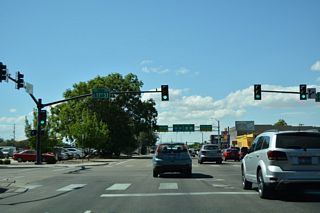 Westbound U.S. 20/26 (Front Street) at the signalized intersection with 11th Street. 11th Street leads south to River Street and north to Washington Street at Boise High School.