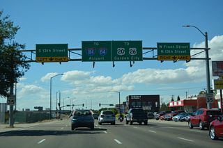 U.S. 20/26 transitions from Front Street onto a freeway viaduct leading to Interstate 184 beyond 13th Street. The Boise Connector crosses the Boise River west to Chinden Boulevard in Garden City.