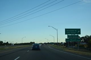 The diamond interchange at Exit 308 joins U.S. 20 west with Riverside Drive south along the Snake River and Fremont Avenue north ahead of the Idaho National Laboratory.