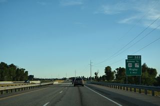 U.S. 20 Business through the Jefferson County seat of Rigby runs 1.65 miles south from Exit 322.