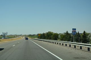 Interstate 84 spans Business Loop I-84/U.S. 30-ID 24 and the adjacent Union Pacific Railroad tracks ahead of this westbound confirming marker.