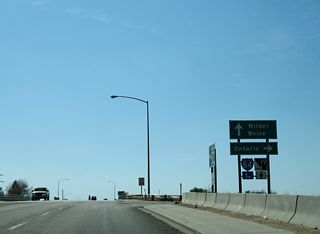 I-84/U.S. 20-26-30 proceed across the Boise River from the west end of Business Loop I-84 in Caldwell. SH 19 is posted alongside Centennial Way south to Simplot Boulevard, where the state highway branches west to Greenleaf and Wilder.