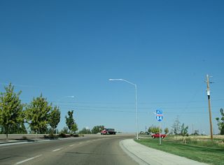 Centennial Way runs along Whittenberger Park north to the diamond interchange (Exit 27) with Interstate 84. Freeport Street ties into the Business Loop ahead of the exchange.