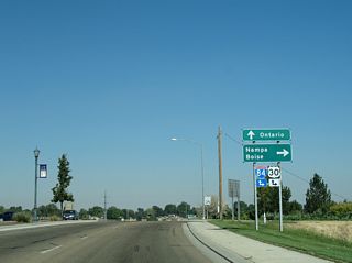 Shields for U.S. 20/26 are omitted on signs for the eastbound I-84 entrance ramp. The four routes overlap east through Caldwell to Exit 29, where U.S. 20/26 separate for Maddens and Boise. I-84/U.S. 30 remain cosigned to Exit 137 at Bliss.