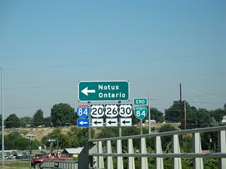 Centennial Way continues 0.60 miles beyond Business Loop I-84 to Illinois Avenue.
