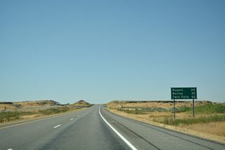 The city of Rupert lies to the east of Burley in 24 miles. Interstate 86 spans Baseline Road (former U.S. 30N) ahead of these terrain cuts.