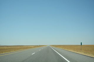 Interstate 86 traverses relatively flat grassy terrain west from mile marker 12.
