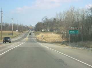 Despite having already entered the city limits, Angola (its downtown) is listed as being three miles away from the Interstate 69 interchange. Columbia, Ohio, and the Ohio Turnpike (Interstate 80/Interstate 90) is 12 miles away.